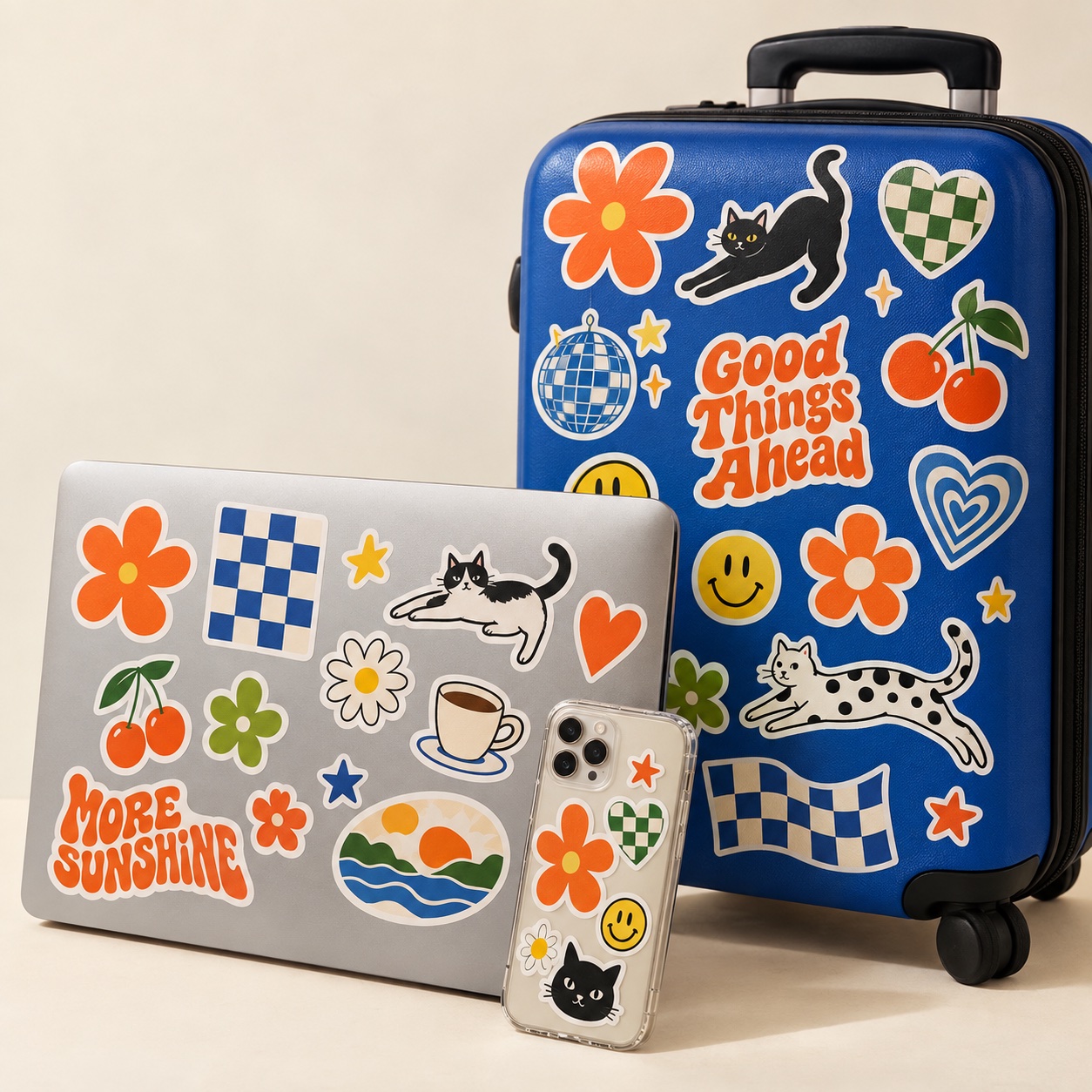 Laptop, phone case and blue suitcase dressed in colorful personal stickers